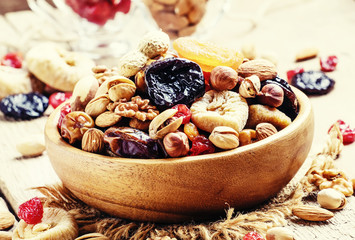 Healthy food: nuts and dried fruit, vintage wooden background, s