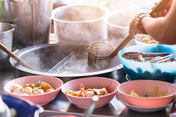 Chinese noodle ripen with spoon dumpling in hot boiled soup in Thailand street food