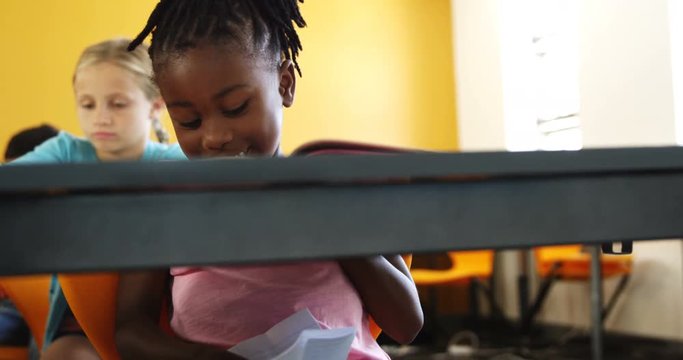Schoolgirl cheating while writing a exam in class