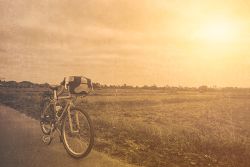 Fototapeta na wymiar bicycle touring travel bike park at summer hot day with grunge texture vintage color tone