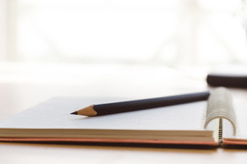 a blank reporters notepad notebook with pencil