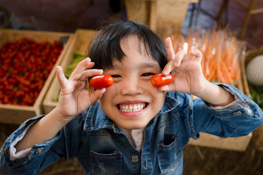 Portrait of happy child with vegetables