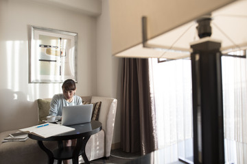 A woman is working on a laptop computer