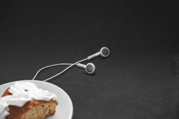 Chocolate cake with headphones on a black background