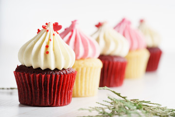 colorful cupcakes on white wooden background