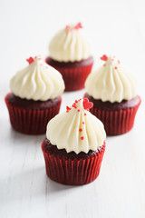 colorful cupcakes on white wooden background