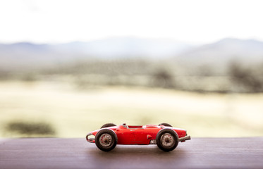 Old red formula one car miniature, vintage and collection, touch of nostalgia