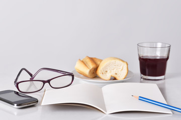 Glasses, pencil smartphone and notebook for planning