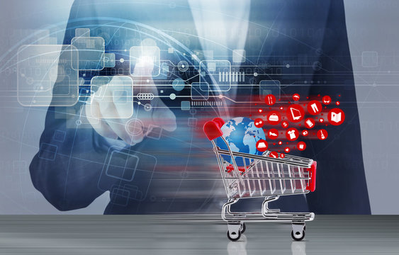 Online shopping concept of shopping cart and business woman hand touching technology design