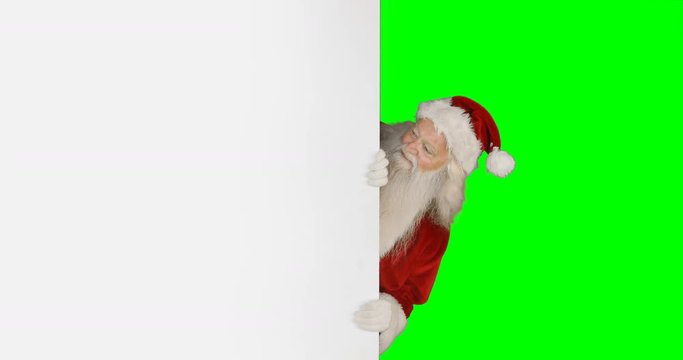 Surprised santa claus hiding behind white screen