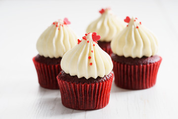 colorful cupcakes on white wooden background