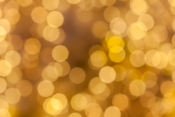 Abstract background blurred yellow golden bokeh circles.