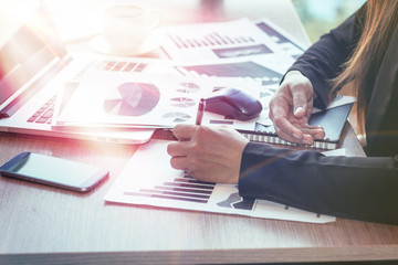 Close Up of woman hands using mobile phone and laptop computer with blank copy space screen for your advertising text message or content business in the Vintage effect.