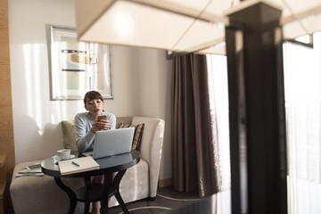 A woman is killing time with a smartphone