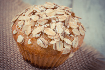 Vintage photo, Fresh muffin with oatmeal baked with wholemeal flour, delicious healthy dessert