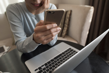 A woman is killing time with a smartphone