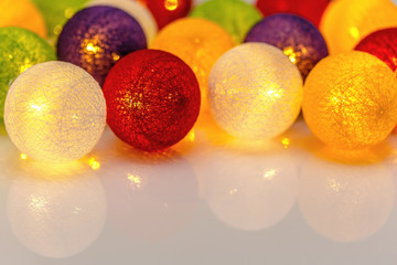 Bright Christmas garland spheres from threads on a white background