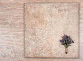 Delicate bouquet of flowers and a wooden abstract background. Limonium.