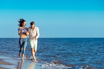 happy couple running on the beach