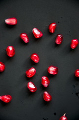 Pomegranate seeds on a black background