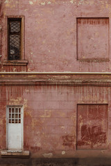 Fototapeta na wymiar Vintage door and window on a background of old red wall