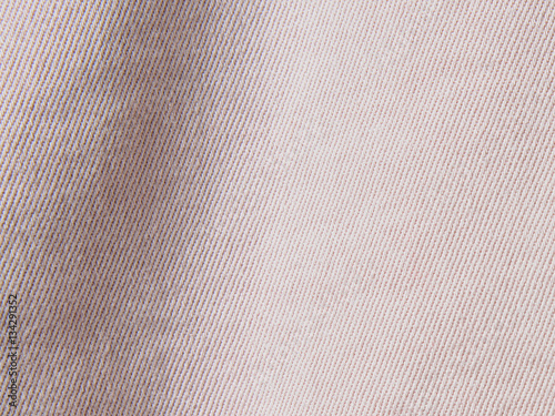 “Closeup of pale pink denim fabric jeans background texture with copy
