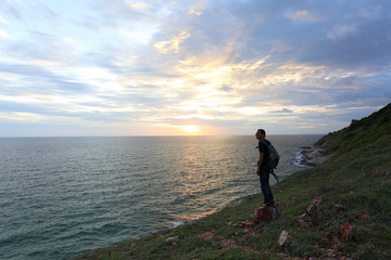 Man standing at Khao Laem Ya national park and sunset in Rayong ,Thailand