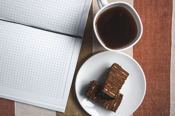 Сoffee mug, cake, notebook