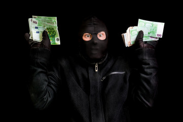 Arrested thief in balaclava with stolen money and raised arms