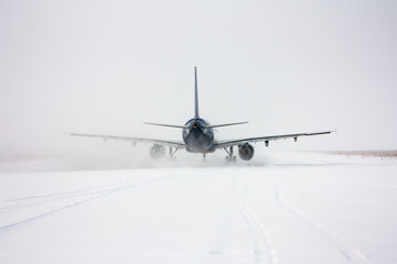 Taxiing passenger aircraft in a snow blizzard