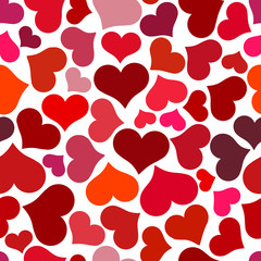 Seamless pattern with red hearts. Swirling red hearts on a white background. Vector valentine illustration.
