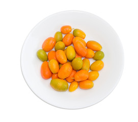 Kumquats on white dish on a light background