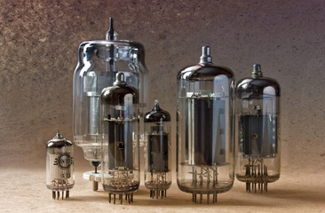 electronic background with vintage vacuum tubes on kraft paper.