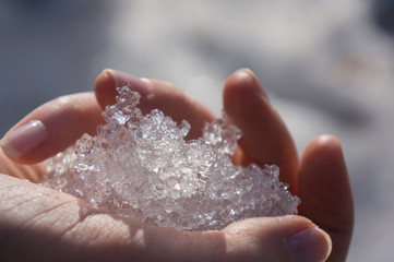 Girl with a frozen hand, shows a beautiful, glowing ice