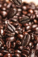 Dark coffee beans falling on the table