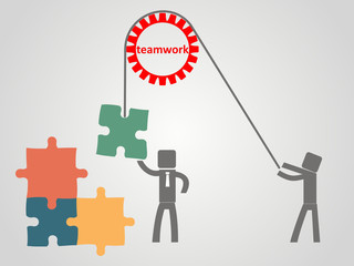 teamwork concept - an employee raises a puzzles on a rope