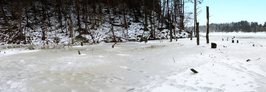 Panoramic image of a frozen lake in winter