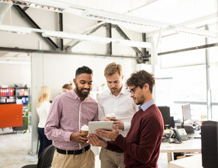 business team with tablet pc and coffee at office