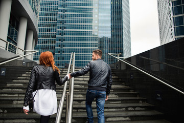 Couple walking in urban city, boy and girl in love holding hands