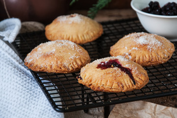 Blueberry hand pies sprinkled with sugar on wooden table