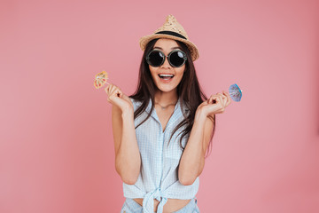 Young woman holding little toy umbrellas.