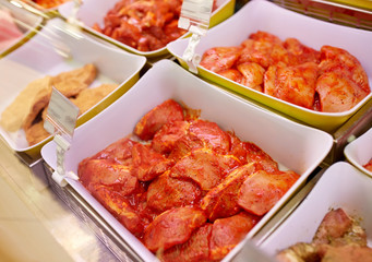 marinated meat in bowls at grocery stall