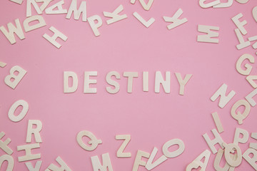 Sorting letters Destiny on pink.