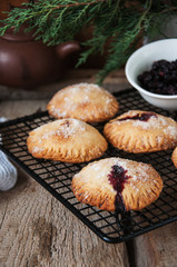 Blueberry hand pies sprinkled with sugar on wooden table