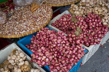 Red onion and garlic in basket and container at the local market
