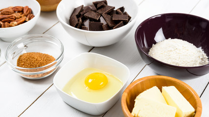 Pecan Nuts, Dark Chocolate Pieces, Sugar, Egg Yolk And Butter On Kitchen Table
