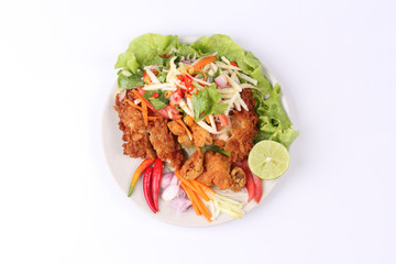 Spicy deep-fried chicken salad with roll green mango .