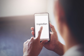 Man holding his mobile for the vision in cross processing and instagram like.