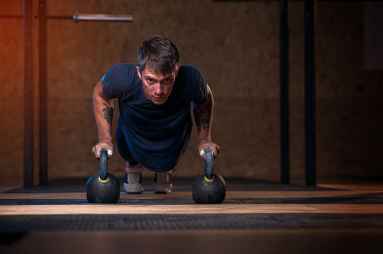 Young Muscular Man Training With Kettle Bell