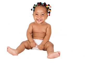 picture of happy baby girl sitting and drawing her diaper